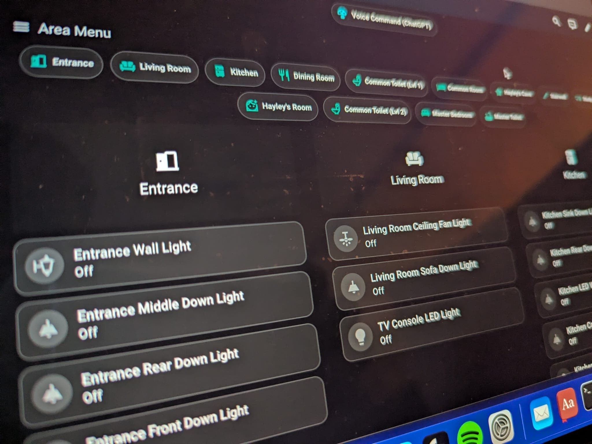 Home Assistant dashboard displayed on a MacBook showing room controls